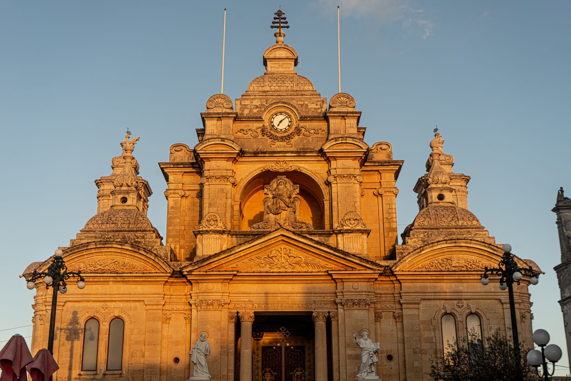 Golden light illuminates St. John's Co-Cathedral in Valletta, Malta, highlighting its Baroque architecture.